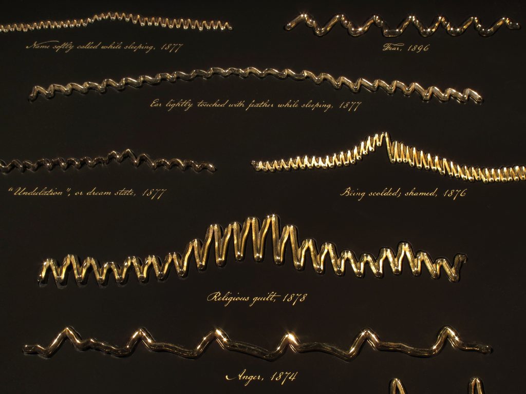 Dario Robleto (b. 1972), Unknown and Solitary Seas (Dreams and Emotions of the 19th Century) (detail), 2018, earliest waveform recordings of blood flowing from the heart and in the brain during sleep, dreaming, and various emotional states (1874–96), rendered and 3D printed in brass-plated stainless steel; lacquered maple, and 22k gold leaf, Courtesy of the artist, © Dario Robleto
